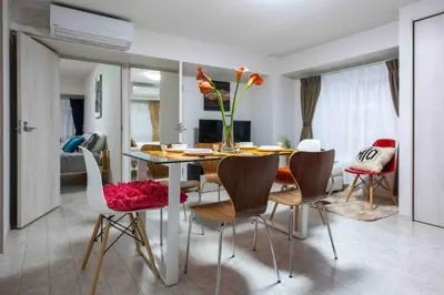 a dining room and living room with a table and chairs at Asakusa 2 Bedroom Apartment \u897f\u6d45\u83492LDK\u5e83\u3005\u30d5\u30a1\u30df\u30ea\u30fcor\u30b0\u30eb\u30fc\u30d7 in Tokyo