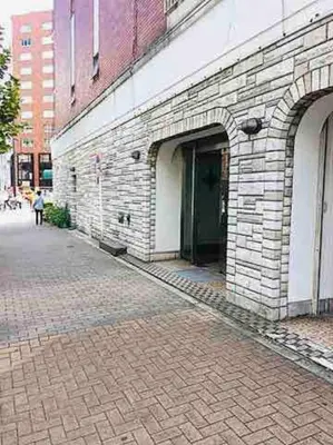 a brick building with an open door on a street at Asakusa 2 Bedroom Apartment \u897f\u6d45\u83492LDK\u5e83\u3005\u30d5\u30a1\u30df\u30ea\u30fcor\u30b0\u30eb\u30fc\u30d7 in Tokyo