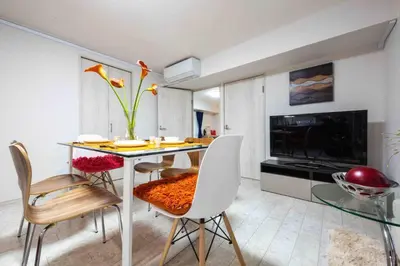 a living room with a dining room table and chairs at Asakusa 2 Bedroom Apartment \u897f\u6d45\u83492LDK\u5e83\u3005\u30d5\u30a1\u30df\u30ea\u30fcor\u30b0\u30eb\u30fc\u30d7 in Tokyo