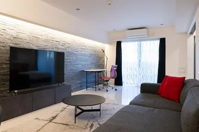 a living room with a couch and a flat screen tv at CREAL premier\u8d64\u5742 in Tokyo