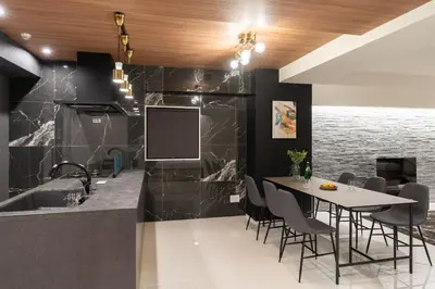 a dining room with a table and a tv on a wall at CREAL premier\u8d64\u5742 in Tokyo