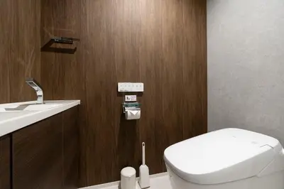 a bathroom with a white toilet and a sink at CREAL premier\u8d64\u5742 in Tokyo