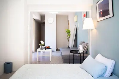 a living room with a bed and a chair at #8 3mins to station 1stop to Shinjuku Central Shinjuku apartment with plenty of Sunlight in Tokyo