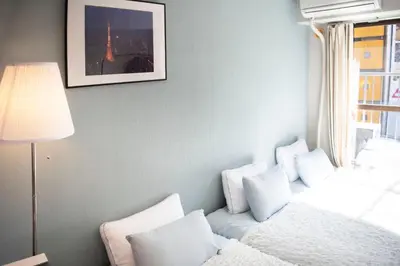 a bedroom with a bed with white pillows and a window at #8 3mins to station 1stop to Shinjuku Central Shinjuku apartment with plenty of Sunlight in Tokyo