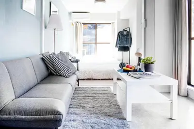 a living room with a couch and a table at #8 3mins to station 1stop to Shinjuku Central Shinjuku apartment with plenty of Sunlight in Tokyo