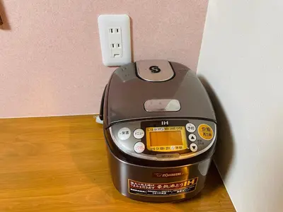 a toaster sitting on the floor next to an outlet at Asakusa，2BR Cozy Detached House，10mins to Sensō-ji in Tokyo