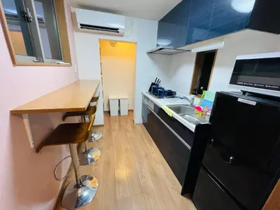 a small kitchen with a sink and a counter at Asakusa，2BR Cozy Detached House，10mins to Sensō-ji in Tokyo