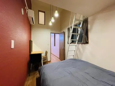 a bedroom with a bed and a ladder and a desk at Asakusa，2BR Cozy Detached House，10mins to Sensō-ji in Tokyo
