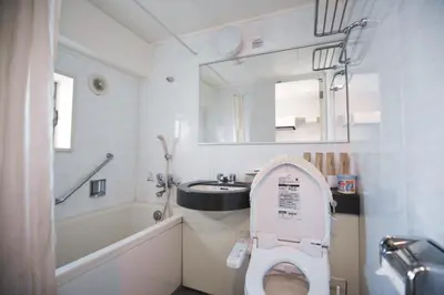 a bathroom with a toilet and a sink and a mirror at self-check in-5mins walk from shinokubo station free wifi in Tokyo