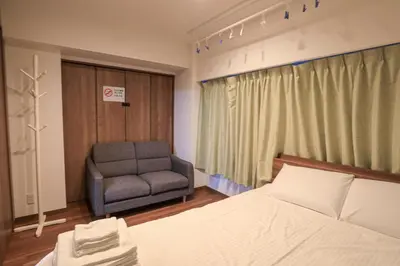 a bedroom with a bed and a chair and a window at self-check in-5mins walk from shinokubo station free wifi in Tokyo