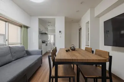 a living room with a couch and a dining room table at self-check in-5mins walk from shinokubo station free wifi in Tokyo