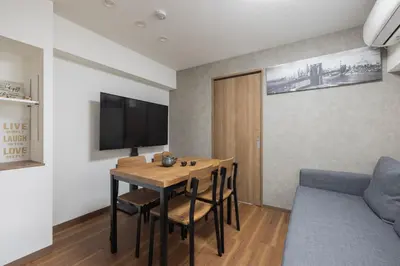 a dining room with a table and a couch at self-check in-5mins walk from shinokubo station free wifi in Tokyo