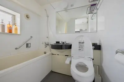 a bathroom with a toilet and a sink and a mirror at self-check in-5mins walk from shinokubo station free wifi in Tokyo