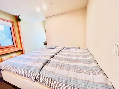 a bedroom with a bed in a room at \u6c60\u888bApila in Tokyo