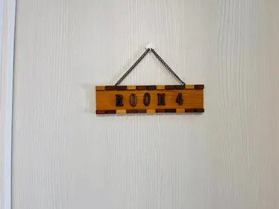a wooden sign with the word doom hanging on a wall at \u6c60\u888bApila in Tokyo