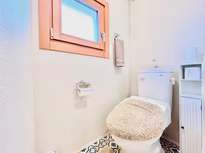 a bathroom with a toilet and a window at \u6c60\u888bApila in Tokyo
