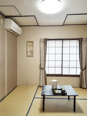 a room with a table in front of a large window at HOTEL HOUSE LEE in Tokyo