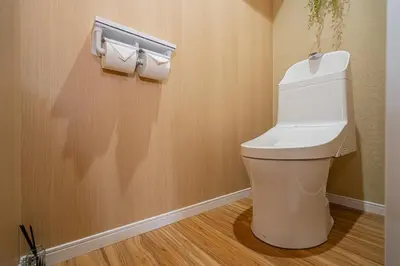 a bathroom with a toilet and two rolls of toilet paper at Sakura Suite in Tokyo