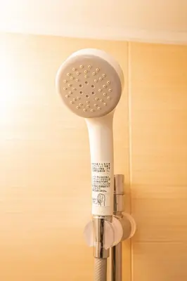a white toothbrush is attached to a wall at Sakura Suite in Tokyo