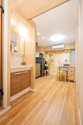 a kitchen with wooden flooring and a dining room at Sakura Suite in Tokyo