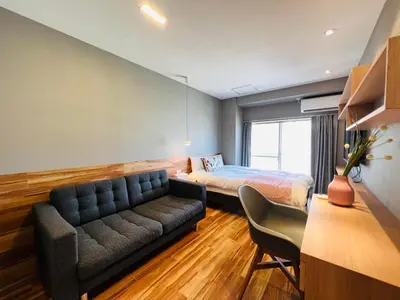 a bedroom with a bed and a couch in a room at ZDt-612-SJ0152 in Tokyo