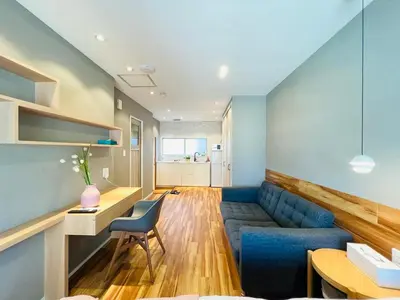 a living room with a blue couch and a table at ZDt-612-SJ0152 in Tokyo