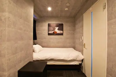 a small bedroom with a bed and a table at Regalo shibaura 801 in Tokyo