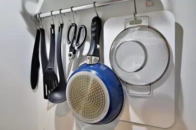 a bunch of kitchen utensils hanging from a rack at Regalo shibaura 801 in Tokyo