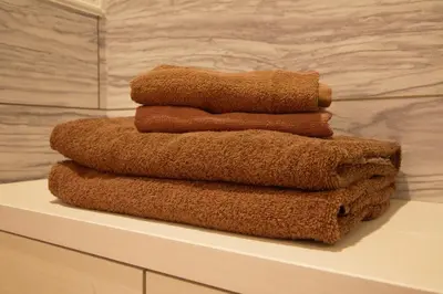 a stack of towels sitting on a shelf in a bathroom at Regalo shibaura 801 in Tokyo