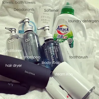 a bunch of cleaning products sitting on a bed at 浅草スカイツリービューテラス 浅草寺3分 浅草駅6分 2-10人 成田&羽田空港直通 in Tokyo