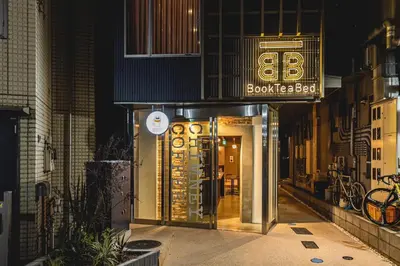 a door to a store with a sign on it at Book Tea Bed SHIBUYA in Tokyo