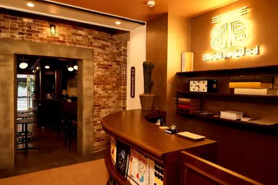 a bar in a restaurant with a brick wall at Book Tea Bed SHIBUYA in Tokyo