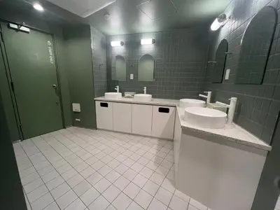 a bathroom with two sinks and two mirrors at Book Tea Bed SHIBUYA in Tokyo