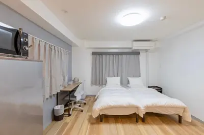 a bedroom with a bed and a desk and a television at Humming Kinshicho 303 - Vacation STAY 14235 in Tokyo