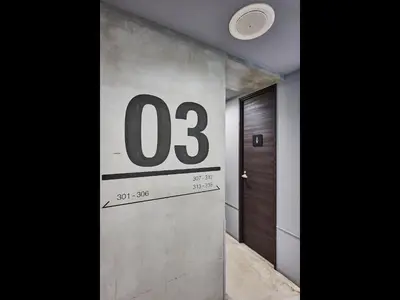 a room with a door and a number on the wall at Hotel Plus Hostel TOKYO AKIHABARA in Tokyo