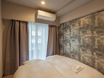 a bedroom with a bed with a pillow on it at Hotel Plus Hostel TOKYO AKIHABARA in Tokyo