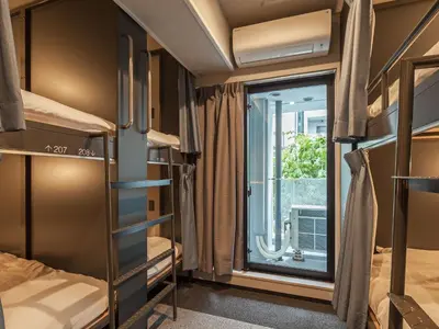 a room with bunk beds and a window at Hotel Plus Hostel TOKYO AKIHABARA in Tokyo