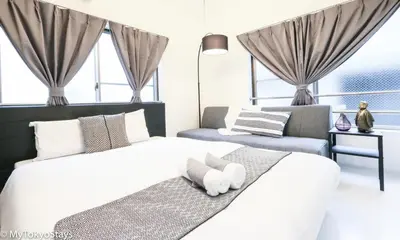 a bedroom with two beds with a stuffed animal on the bed at NEW! Studio Modern Unit in Shibuya Scramble! in Tokyo