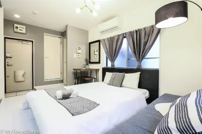 a bedroom with a large white bed and a window at NEW! Studio Modern Unit in Shibuya Scramble! in Tokyo