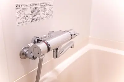 a toilet paper dispenser on a wall next to a sink at \u548c\u7e01WAEN SKYTREE in Tokyo