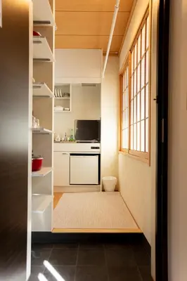 a small kitchen with white cabinets and a window at \u548c\u7e01WAEN SKYTREE in Tokyo