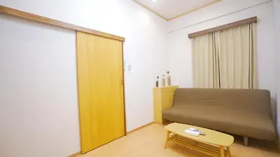 a bedroom with a bed and a bench and a table at \u4e0a\u91ce\u5200\u516b\u6bd8\u6c99\u9580\u5929\u30db\u30c6\u30eb in Tokyo
