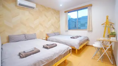 a bedroom with two beds with towels on them at \u4e0a\u91ce\u5200\u516b\u6bd8\u6c99\u9580\u5929\u30db\u30c6\u30eb in Tokyo
