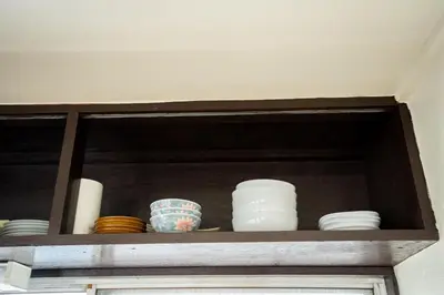 a cabinet with plates and bowls on a shelf at PREMIER suite Shinjuku Akebonobashi front in Tokyo
