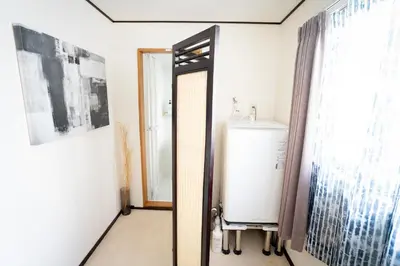 a bathroom with a mirror and a water heater at PREMIER suite Shinjuku Akebonobashi front in Tokyo