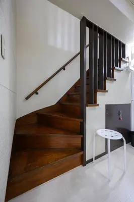 a staircase in a house with wood floors and a stool at PREMIER suite Shinjuku Akebonobashi front in Tokyo