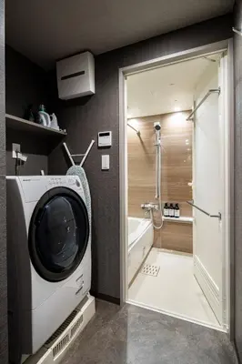 a washing machine in a bathroom with a shower at Section L Yushima-Ueno in Tokyo