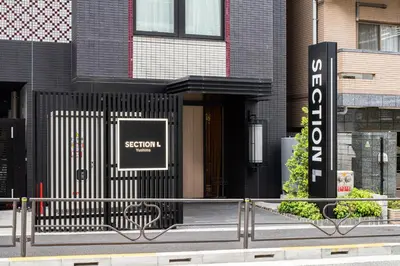 a building with a sign in front of it at Section L Yushima-Ueno in Tokyo