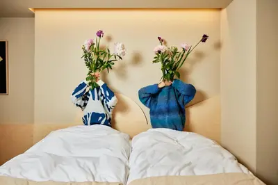 two vases with flowers on the back of a bed at Section L Yushima-Ueno in Tokyo