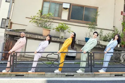 a painting of a group of people standing on a rail at Section L Yushima-Ueno in Tokyo